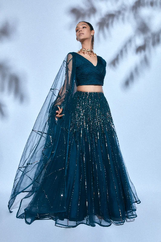 Teal Blouse paired with Teal Hand-embroidered Lehenga and Teal Hand-embroidered Dupatta Asymmetric Hem Blouse Teal Blouse paired with Teal Hand-embroidered Lehenga and Teal Hand-embroidered Dupatta Asymmetric Hem Blouse
